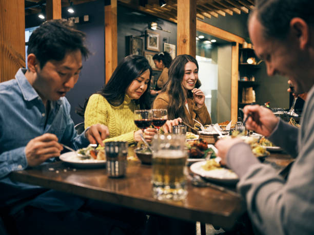 istock Multi Ethnic Group of Friends in an Indian Restaurant 1306032522