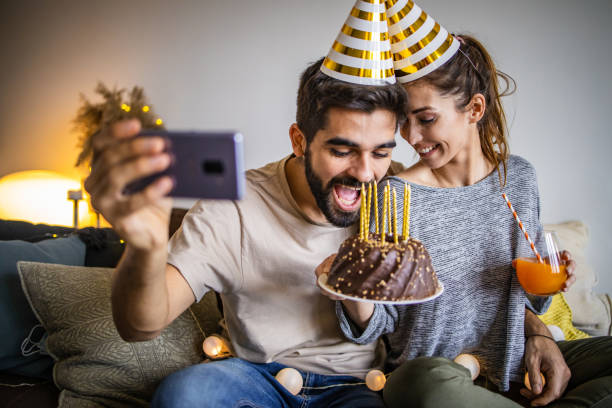 istock Romantic couple with a birthday cake, having a celebration 1306032561