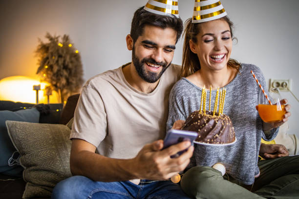 istock Romantic couple with a birthday cake, having a celebration 1306033150