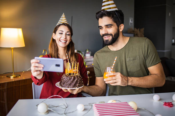 istock Romantic couple with a birthday cake, having a celebration 1306033151