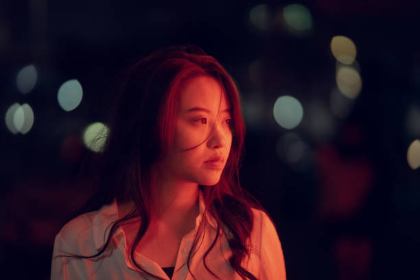 istock Close up of woman face lit with red light. 1306034174