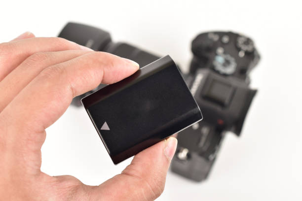 istock Digital camera battery in hand, lithium-ion battery 1306034379