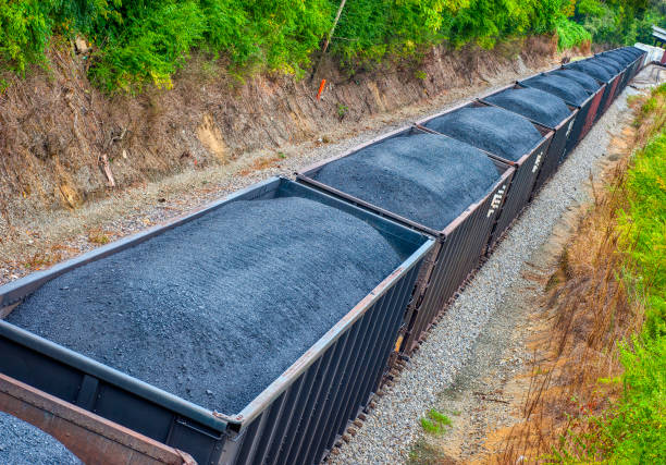 Coal Cars On A Long Freight Train REVISED Horizontal shot of a line of coal cars on a long freight train.  This is a revised image. revised stock pictures, royalty-free photos & images