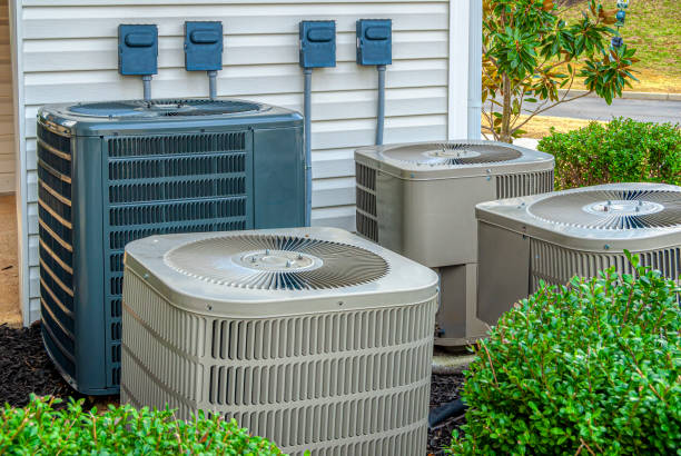 Four Air Conditioning Units Outside Of An Upscale Apartment Complex stock photo