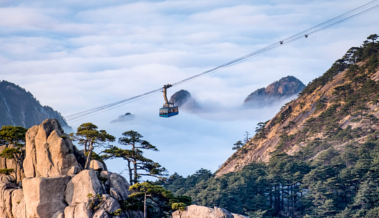 Scenic view of Huangshan yellow mountain cliffs in China from lift cable car and a lot of the mist in the winter season, Huangahan national park is one of  the Unesco world heritage site.