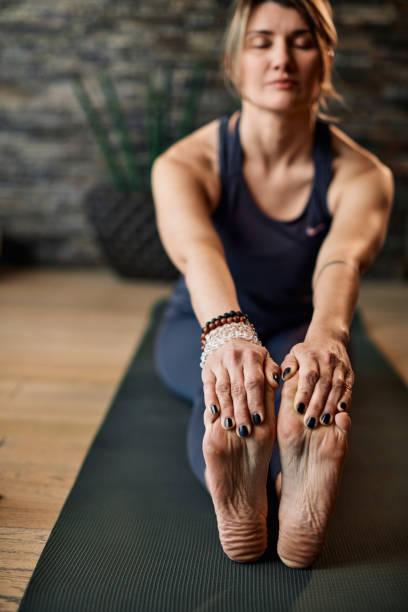 istock A middle-aged woman doing yoga at home. 1306037459