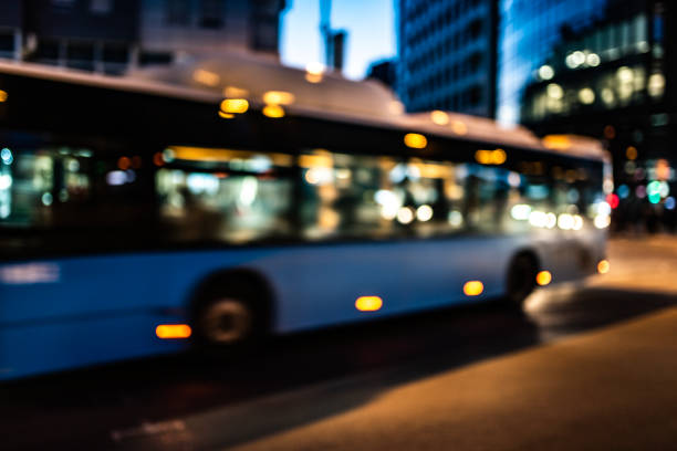 Blurred photo of bus driving in traffic on city street. Lens blur, bokeh.