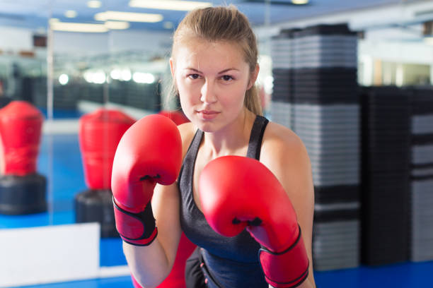 istock Woman boxing in gym 1306040696