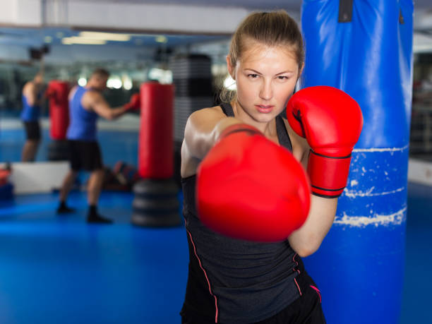 istock Woman boxing in gym 1306040697