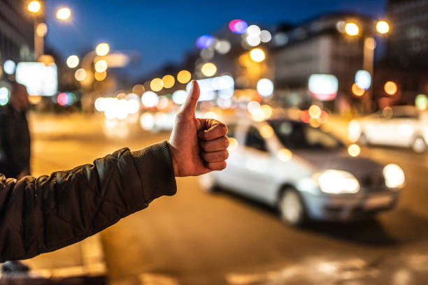 istock Young man looking for transportation on city street. 1306040716