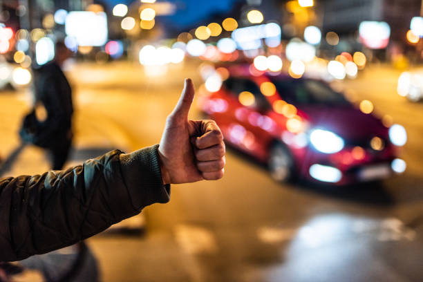 istock Young man looking for transportation on city street. 1306040754