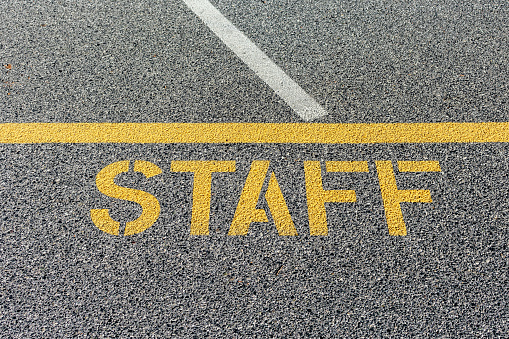 Staff parking sign stenciled on parking lot asphalt