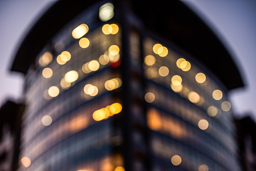Tall office building in the city. Lens blur,bokeh. Background photo.