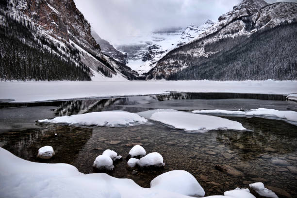 istock Frozen lake with mountain reflections in Canadian Rocky Mountains. 1306043140