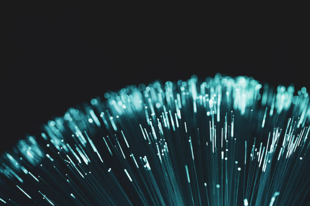 istock Abstract fiber optic turquoise with black background 1306046359