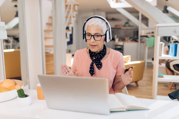 istock Portrait of a senior professor teaching her students online 1306046467