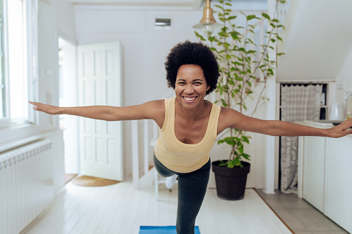 African-American woman exercising at home.