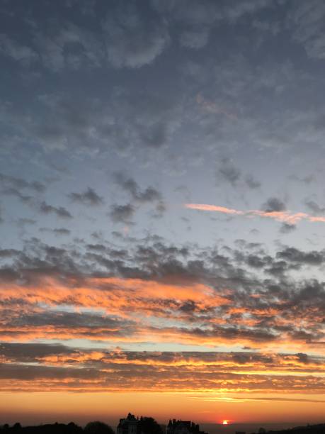 istock Sunset with burnt orange and grey clouds. 1306047420
