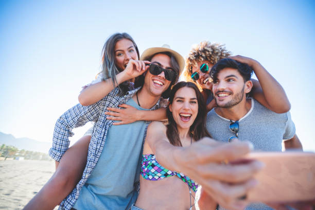 istock Group of friends having fun taking a selfie on the beach. 1306047502