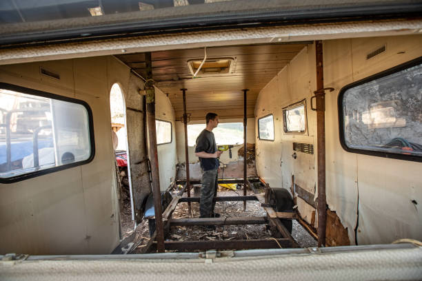istock Young Man Renovating Camper Trailer in Bad Shape 1306049485