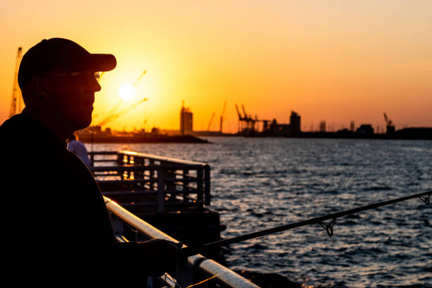 istock Senior man fishing at sunset. 1306050132
