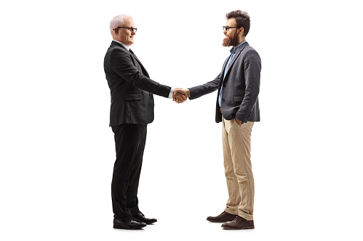 Senior businessman shaking hand with a bearded man isolated on white background