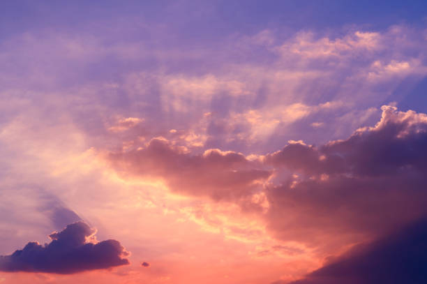 istock Sunbeams breaking through the clouds with blue and orange sky. Hope, prayer concept for background. 1306052316