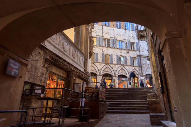istock Street under arch in Siena, Italy 1306052873