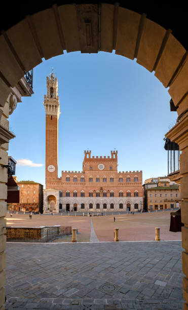 istock Piazza del Campo, Palazzo Pubblico framed by arch window, Siena 1306052933