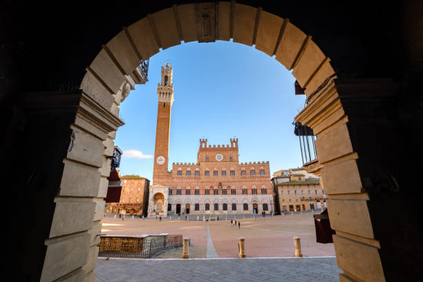 istock Piazza del Campo, Palazzo Pubblico framed by arch window, Siena 1306052998