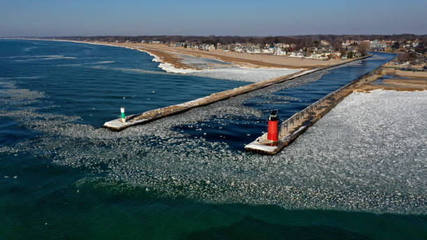 South Haven lighthouse ice melting in spring on Lake Michigan and the Black River.