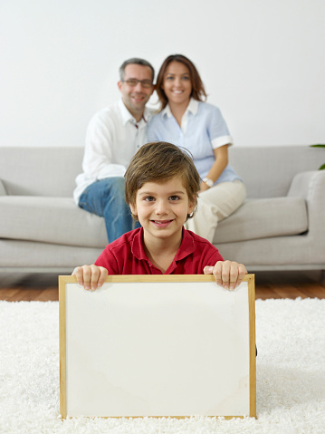 Boy holding blank whiteboard.