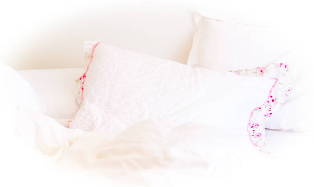 istock White Bed with Pink and WHite Pillows Detail 1306056657