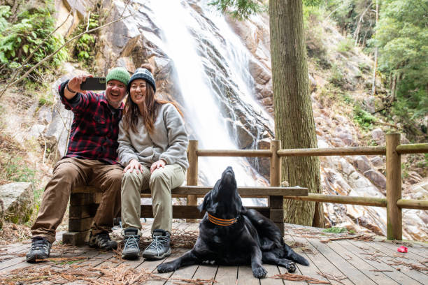 istock Couple taking a selfie by a waterfall 1306061340