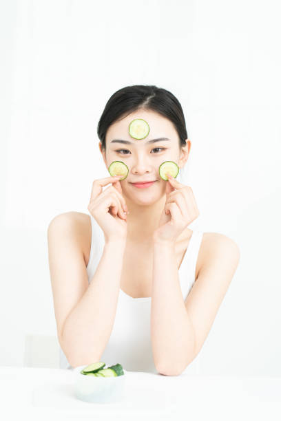 istock Korean beauty is making cucumber mask. 1306062125