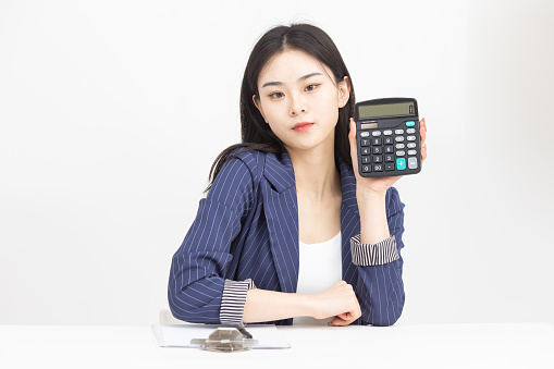 Beautiful asian girl with a calculator