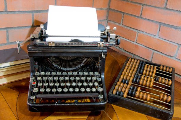 istock An old black and abacus typewriter on an old lacquered table. 1306064653