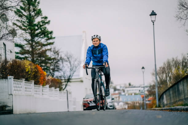 Man cycling on neighbourhood road. Sportsman road cycling.