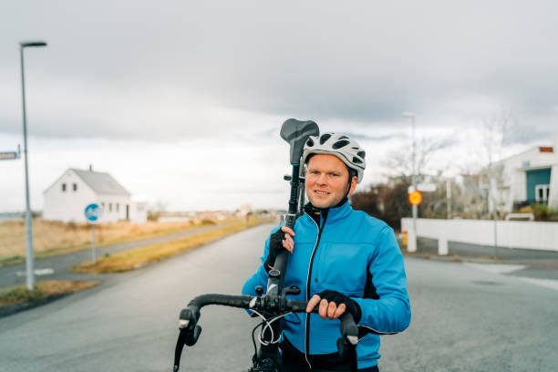 istock Sportsman walking with his bicycle on his shoulder 1306064759