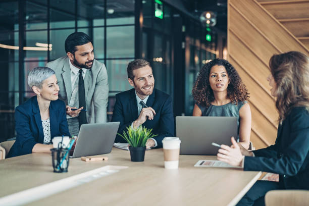istock Multi-ethnic group of entrepreneurs talking around the conference table 1306068823
