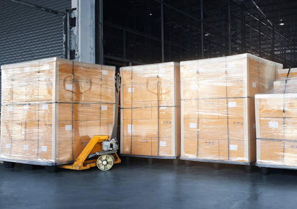 istock Stacked of Package Boxes Wrapped Plastic on Pallet Rack. Interior of Storage Warehouse. Shipping Warehouse Logistics. Industry Cargo Export- Import. 1306069631