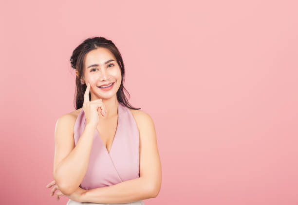 istock woman smiling standing chin handle relaxed thinking about something about the question 1306073976