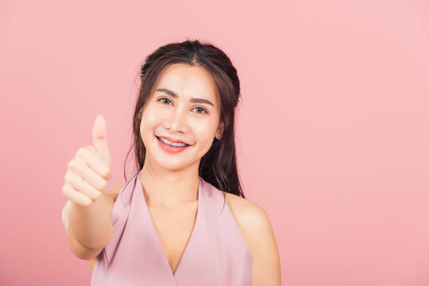 istock woman smile she standing made finger thumbs up 1306073985