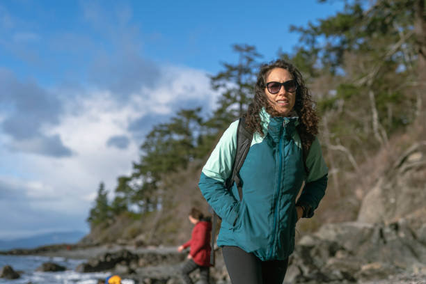 istock Beautiful Ethnic Woman Walking On Beach During Winter 1306074798