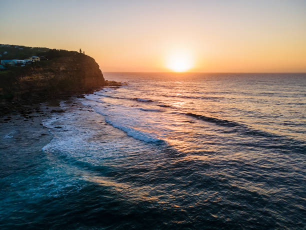 istock Aerial sunrise seascape with hazy blue sky 1306075046
