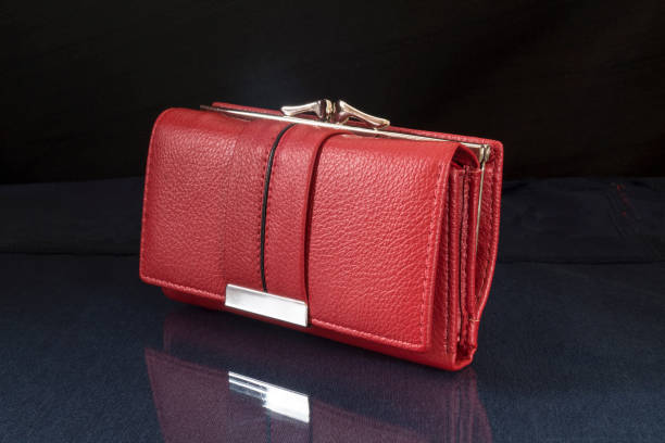 The red wallet is lying on the table with the reflection