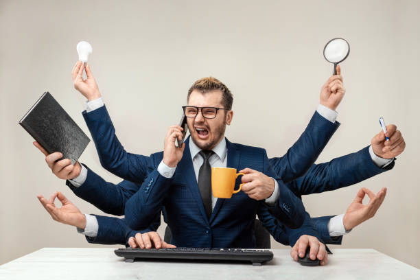 istock Businessman with many hands in a suit. Works simultaneously with several objects, a mug, a magnifying glass, papers, a contract, a telephone. Multitasking, efficient business worker concept. 1306079935
