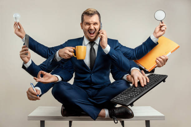 istock Businessman with many hands in a suit. Works simultaneously with several objects, a mug, a magnifying glass, papers, a contract, a telephone. Multitasking, efficient business worker concept. 1306079943