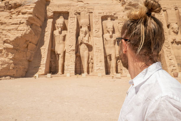 istock Man travels in Egypt, looks at temple 1306080701