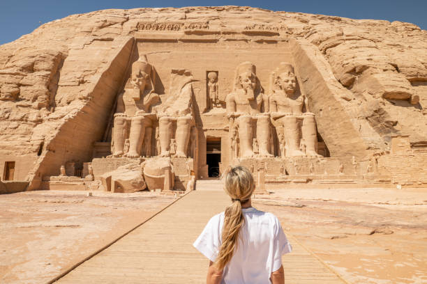 Woman travels in Egypt The Front of the Abu Simbel Temple, Aswan, Egypt, Africa hieroglyphics photos stock pictures, royalty-free photos & images